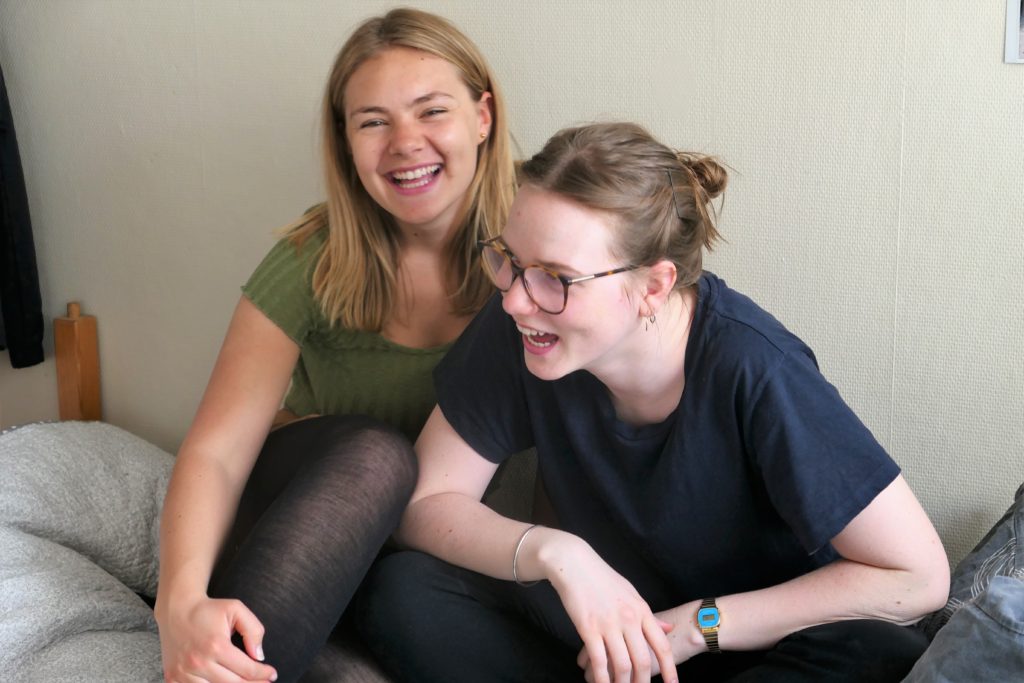 To jenter (19) fra Romerike folkehøyskole ler høyt. Vennskap.