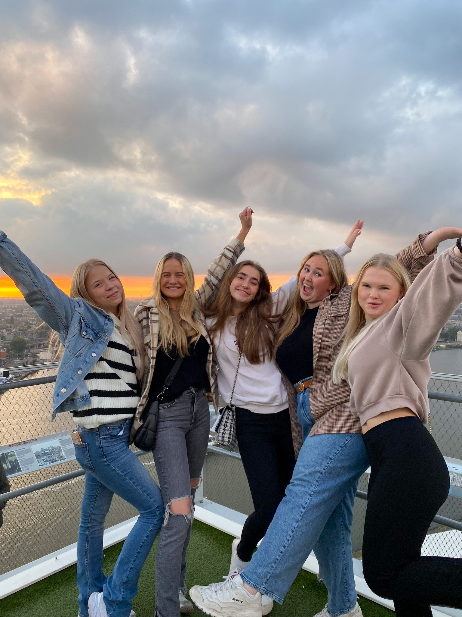 gruppebilde, fem jenter. Alle smiler og har armene i været